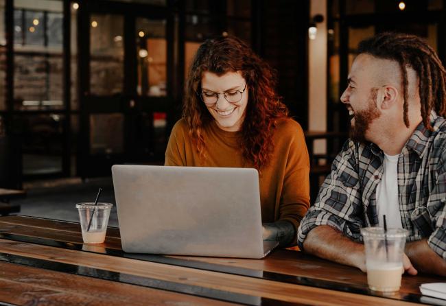 Happy People in front of a Laptop as a symbol for the virtual event entertainment Happy People in front of a Laptop as a symbol for the virtual event entertainment