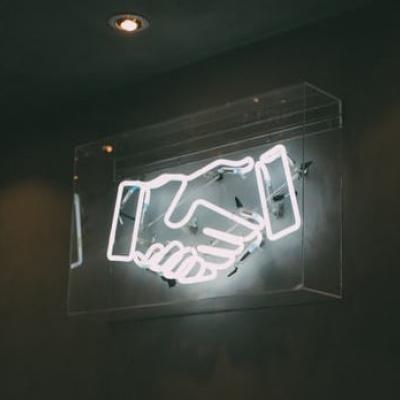 Glowing Handshaking as a symbol for custom communication Glowing Handshaking as a symbol for custom communication